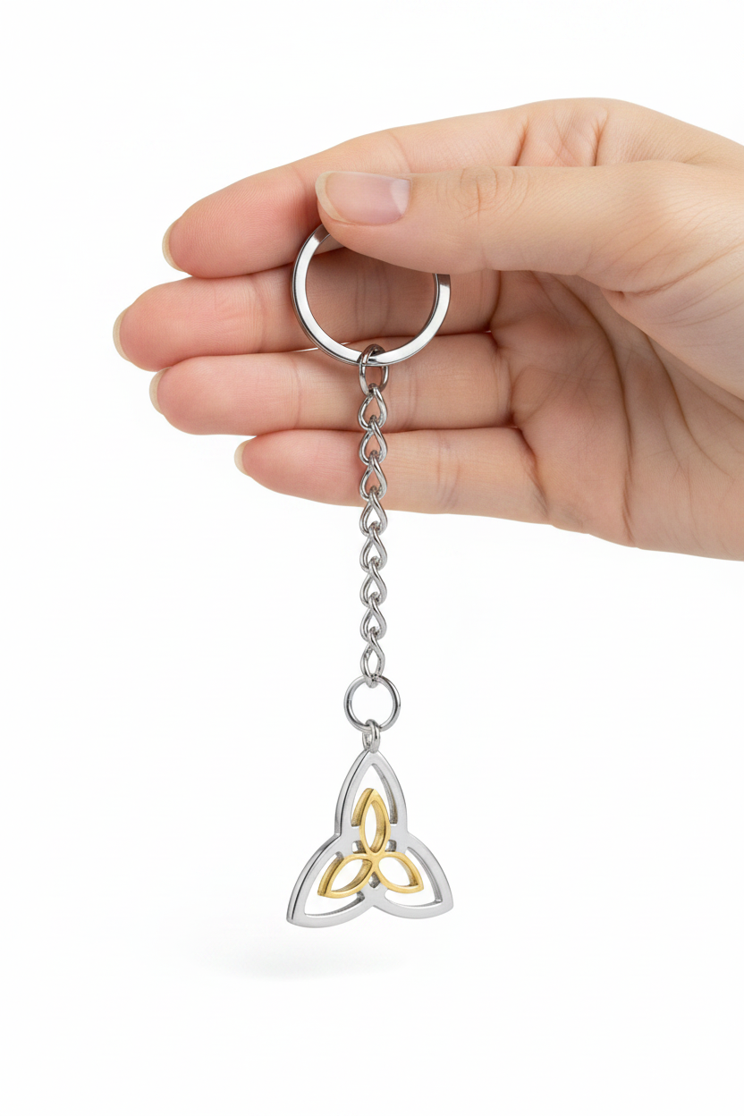 Triquetra Handmade 316L Stainless Steel Charm Keychain held by a hand showing scale.