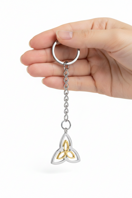 Triquetra Handmade 316L Stainless Steel Charm Keychain held by a hand showing scale.