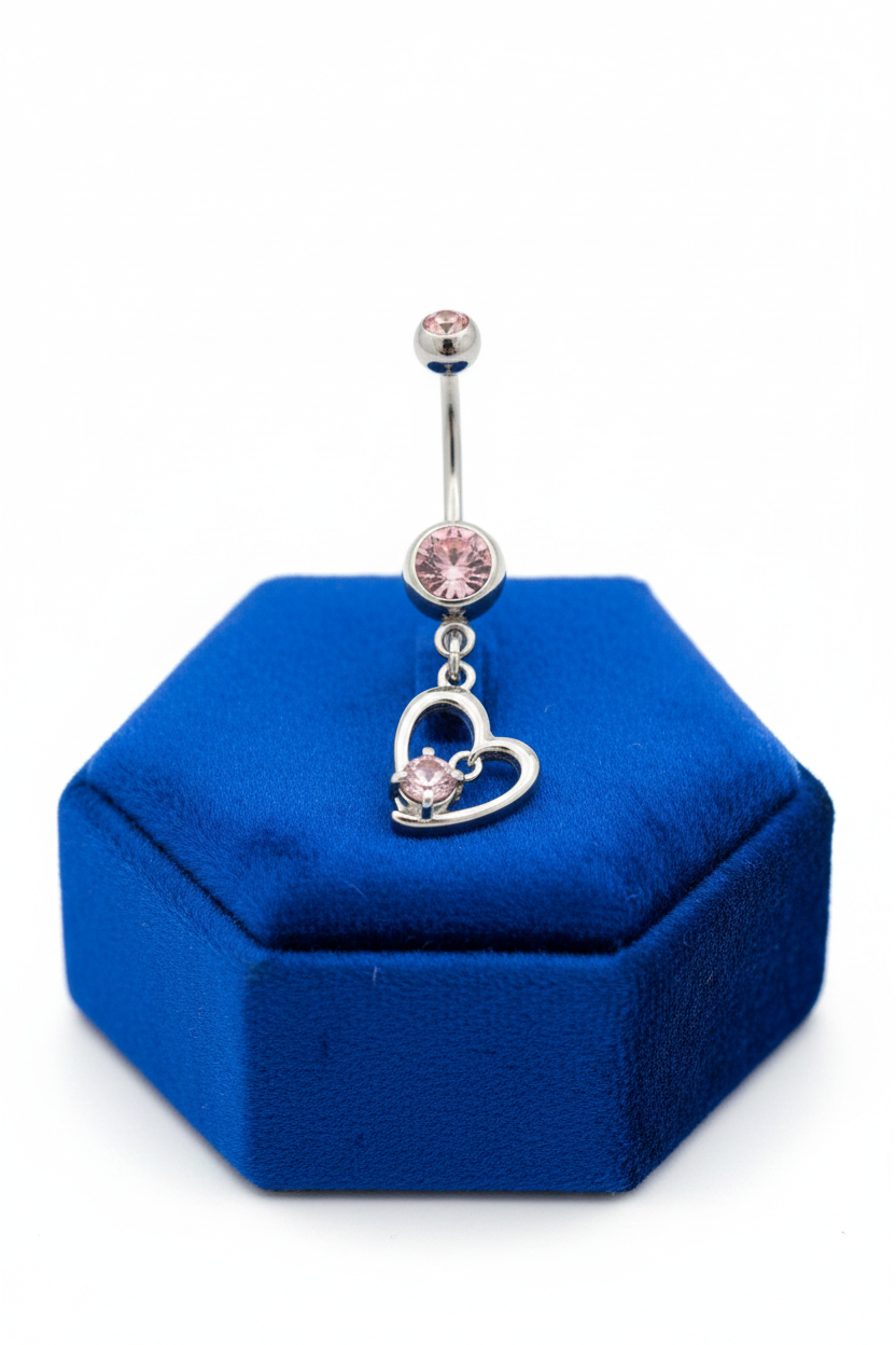 Pink Crystal Heart Belly Button Ring in 316l stainless steel on a blue velvet jewelry display.
