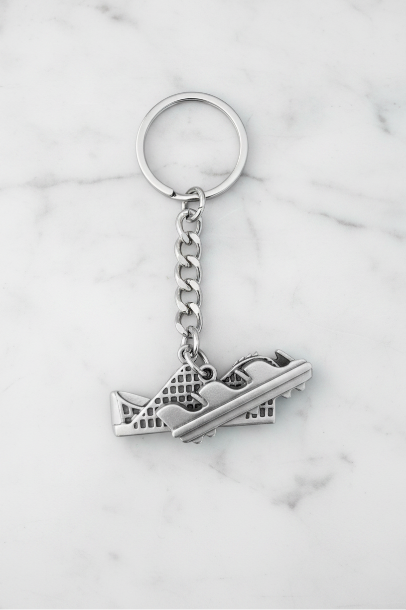 Rollercoaster Ride Handmade Pewter Charm Keychain on a white marble surface.