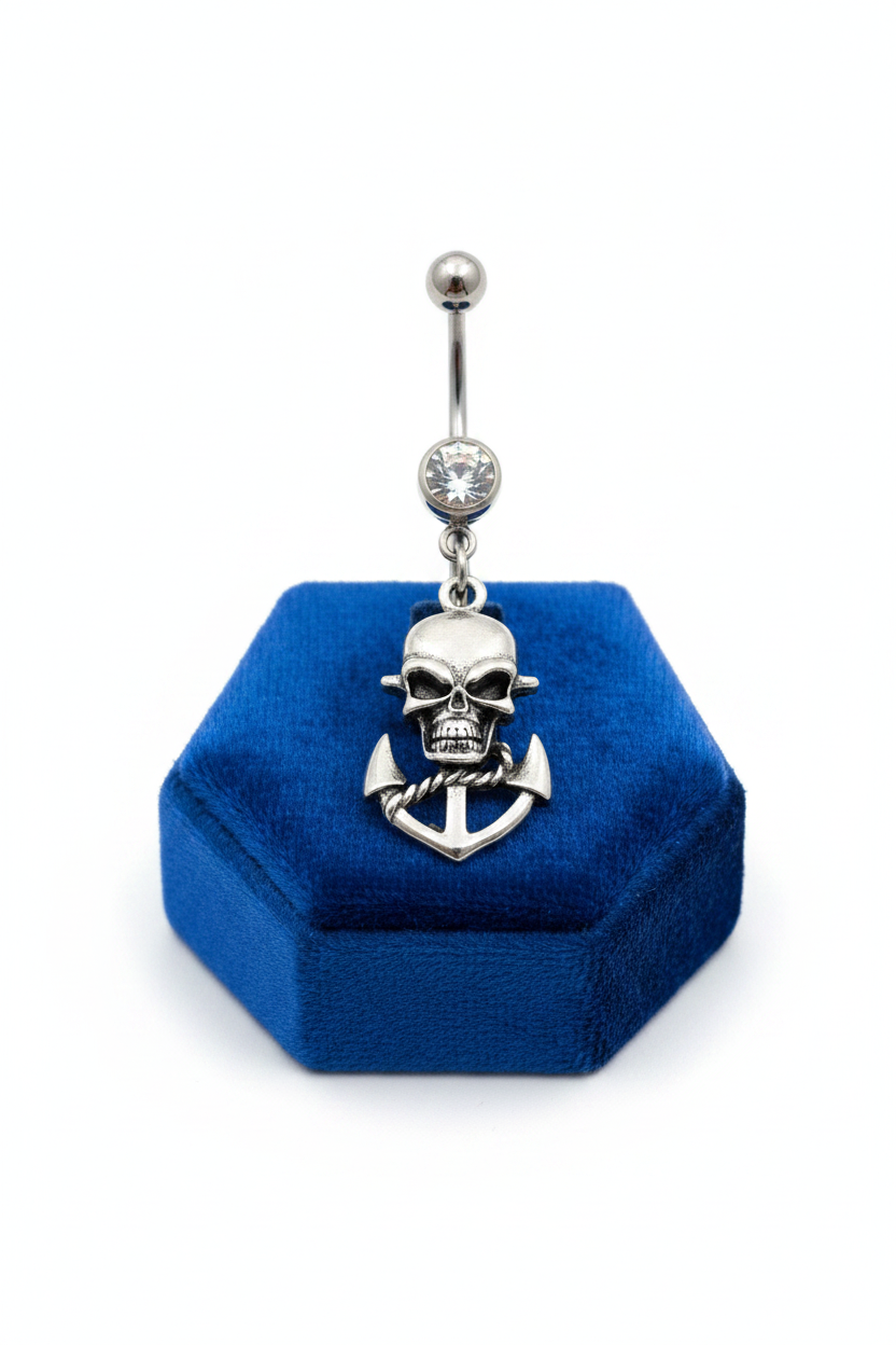 Clear Crystal Skull Anchor Belly Button Ring in 316l stainless steel on a blue velvet jewelry display.
