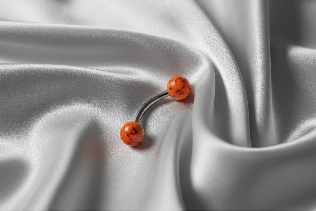 Orange Black Speckled Acrylic Eyebrow Ring in 316l stainless steel.