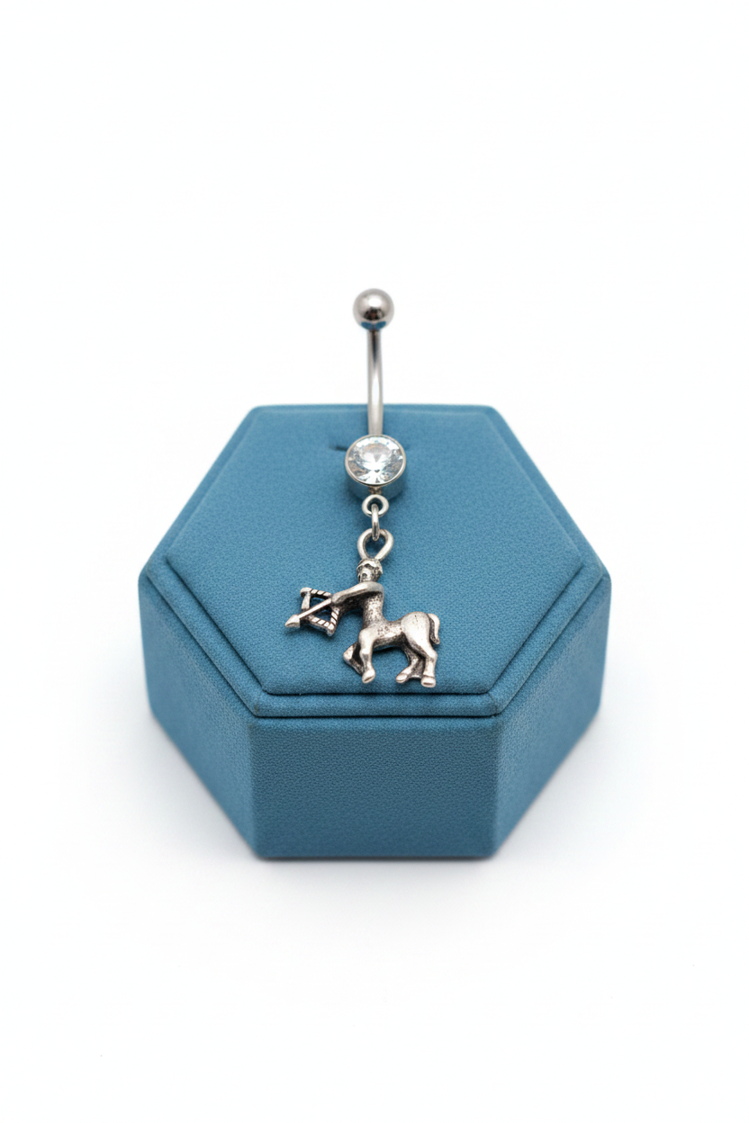 Clear Crystal Sagittarius Belly Button Ring in 316l stainless steel on a blue velvet jewelry display.