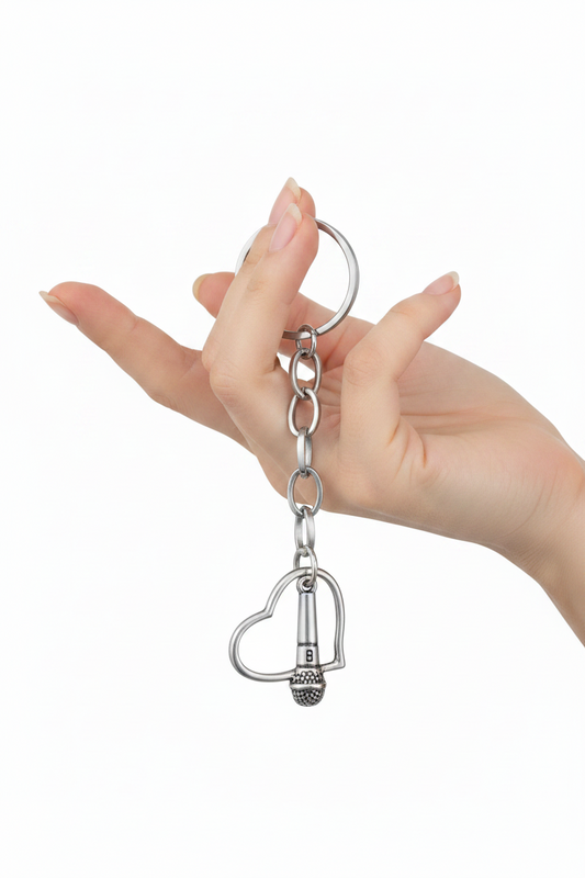 Heart and Microphone Handmade Silver Plated Charm Keychain held by a hand showing scale.