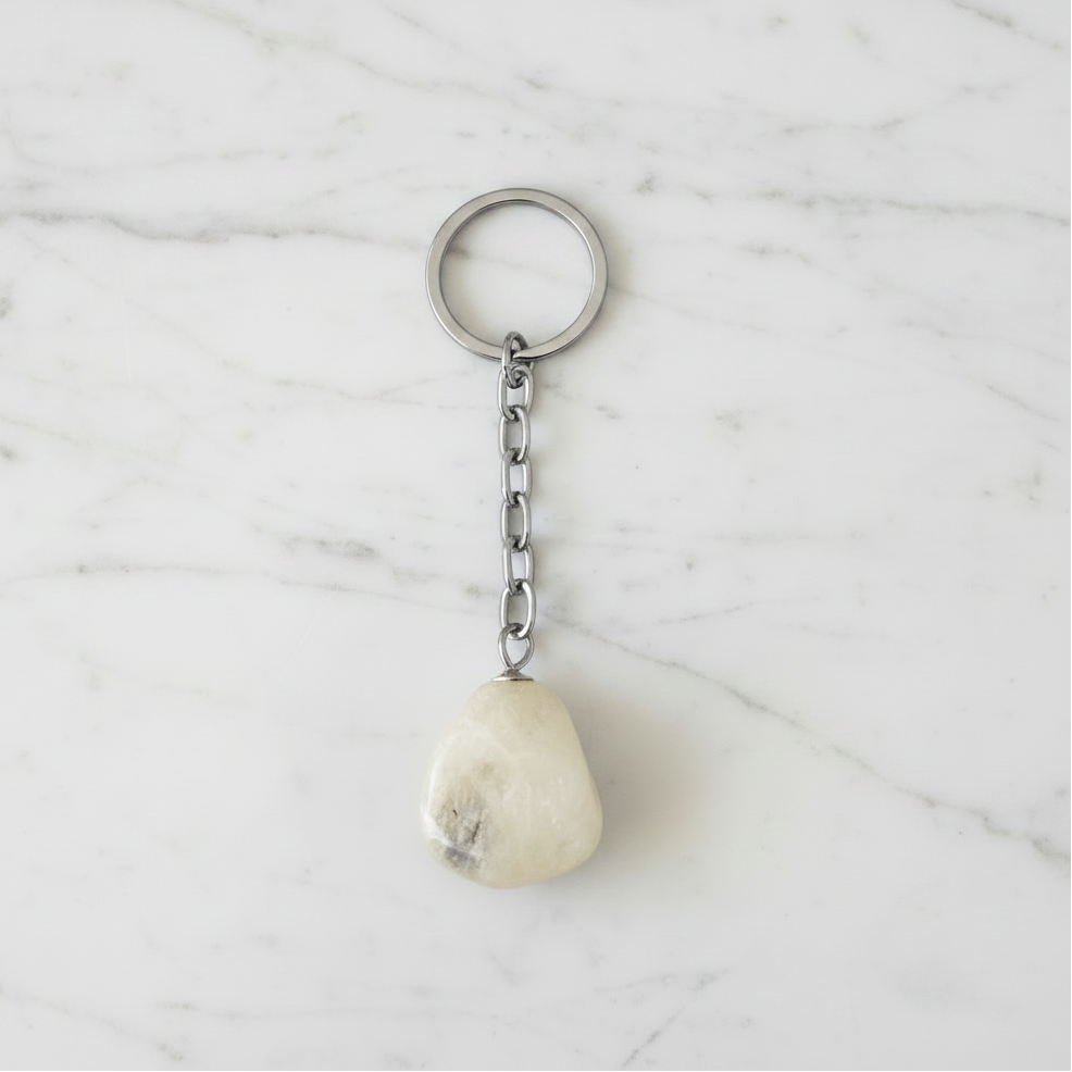 Quartz Natural Earth Stone Handmade Steel Plated Keychain on a white marble surface.