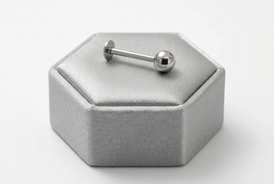 Stainless Steel Ball Labret Lip Ring in 316l stainless steel on a silver silk jewelry display.