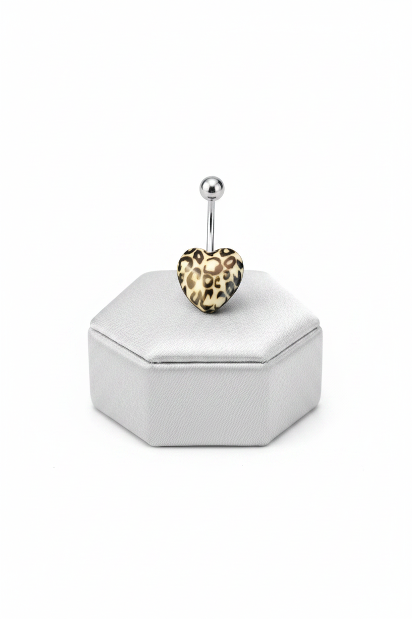 White Leopard Print Heart Acrylic Belly Button Ring in 316l stainless steel on a silver jewelry display.