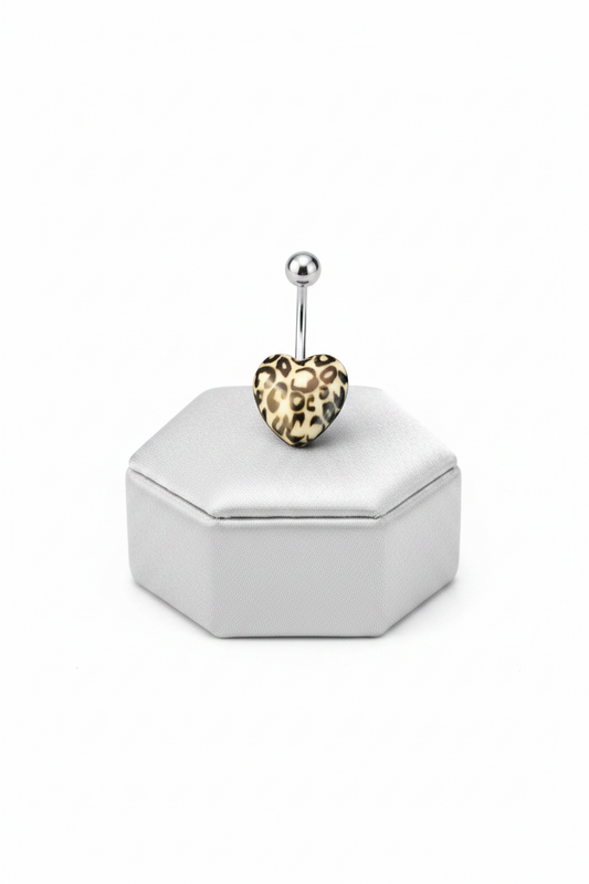 White Leopard Print Heart Acrylic Belly Button Ring in 316l stainless steel on a silver jewelry display.