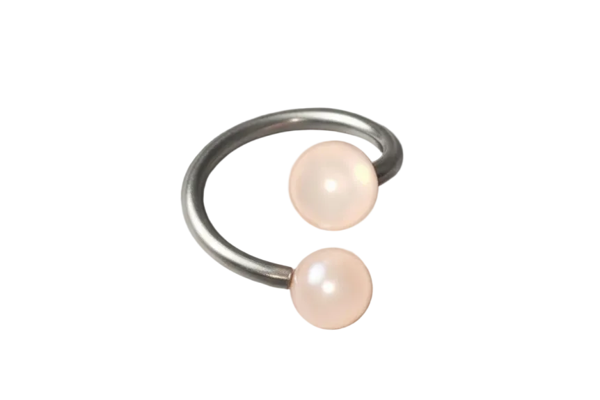 Powder Pink Acrylic Glow Curled Barbell in 316l stainless steel close up detail.