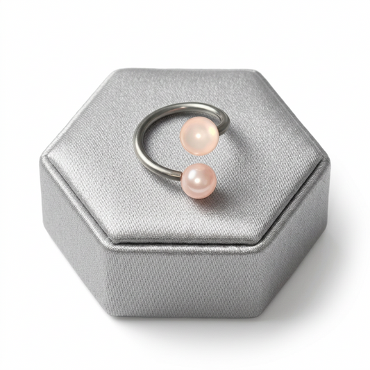 Powder Pink Acrylic Glow Curled Barbell in 316l stainless steel on a silver silk jewelry display.