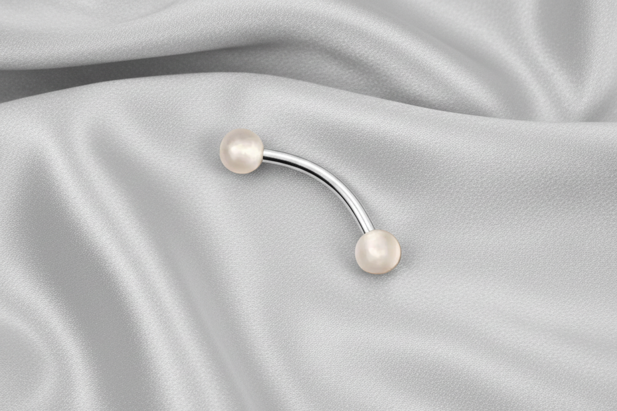 Peach Glow Ball Acrylic Eyebrow Ring in 316l stainless steel.