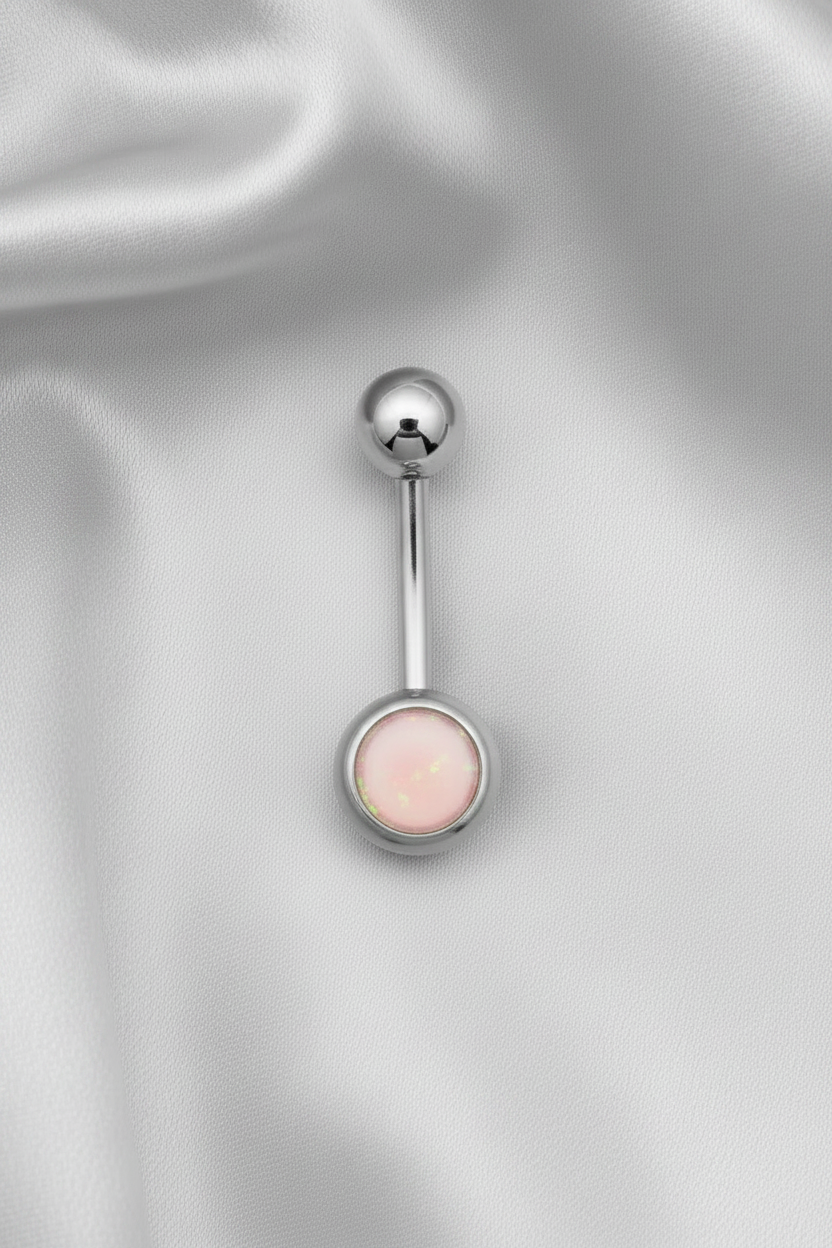 Pink Opal Belly Button Ring in 316l stainless steel on silver silk fabric.