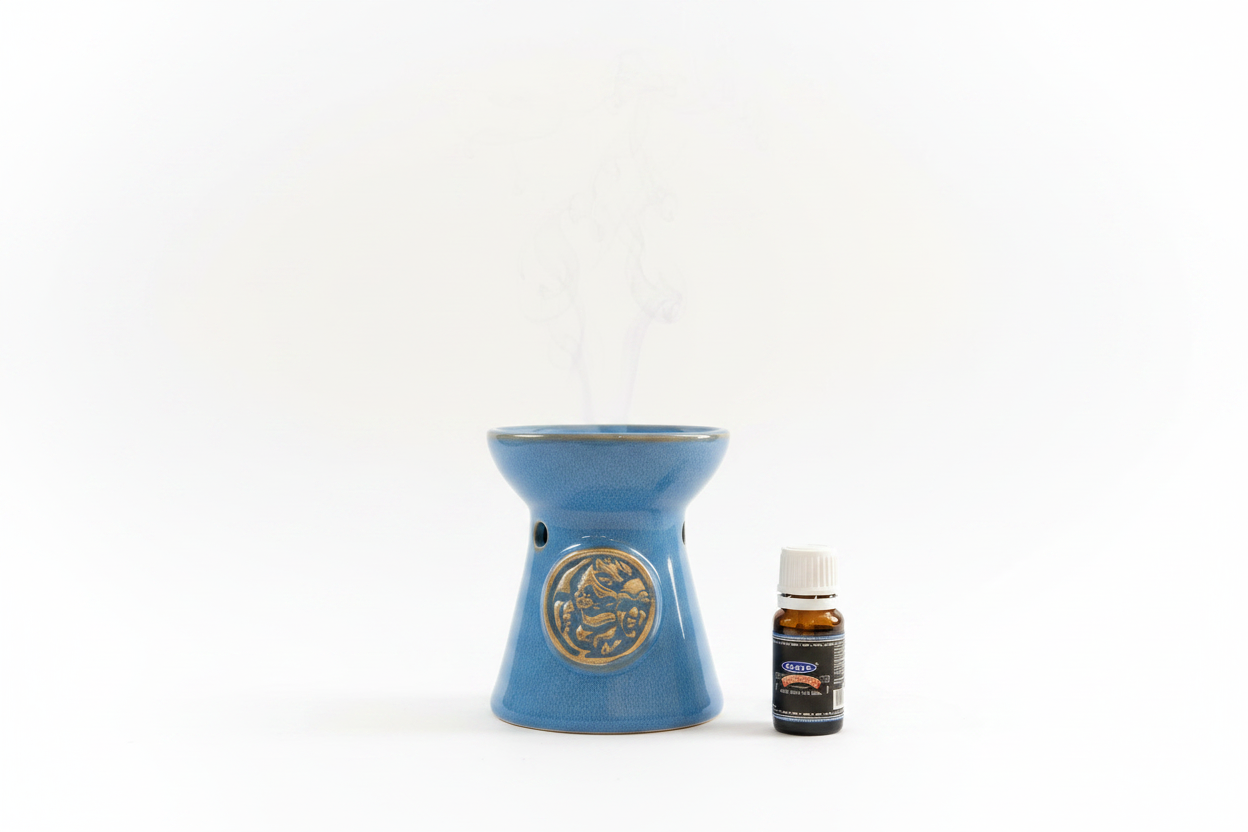 Blue Moon Ceramic Tea Light Essential Oil Warmer on a white background shown with free Satya Superhit essential oil.