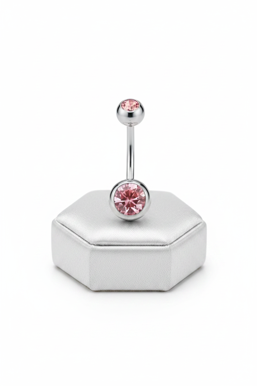 Pink Crystal Belly Button Ring in 316l stainless steel on a silver jewelry display.