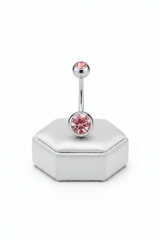 Pink Crystal Belly Button Ring in 316l stainless steel on a silver jewelry display.