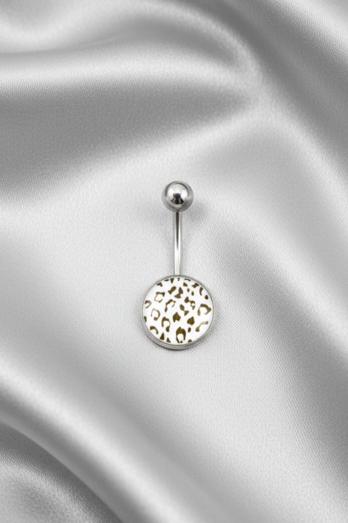 White Leopard Print Belly Button Ring in 316l stainless steel on sliver silk fabric.