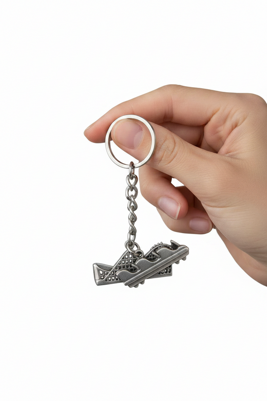 Rollercoaster Ride Handmade Pewter Charm Keychain held by a hand showing scale.
