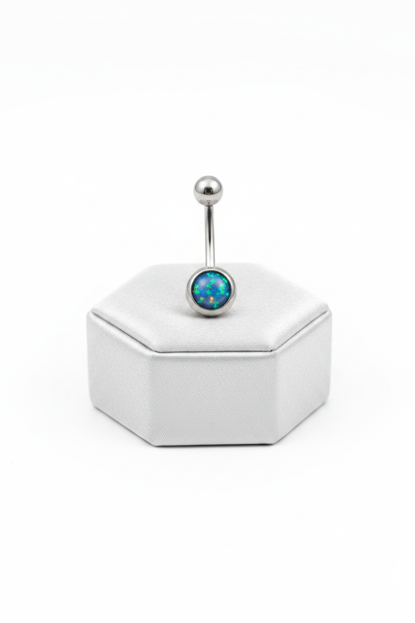Navy Opal Belly Button Ring in 316l stainless steel on a silver silk jewelry display upright position.