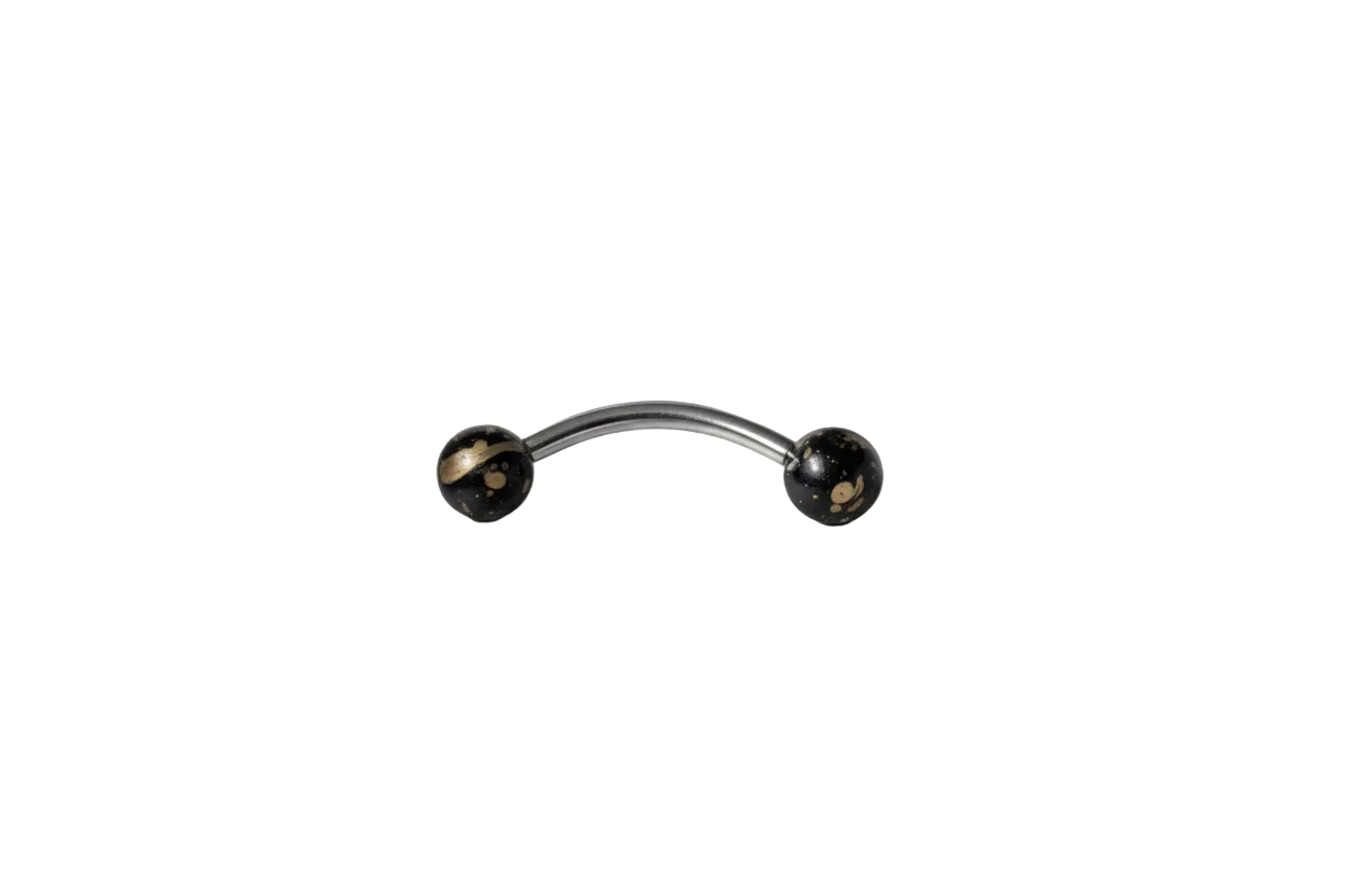 Black Gold Speckled Acrylic Eyebrow Ring in 316l stainless steel close up detail.