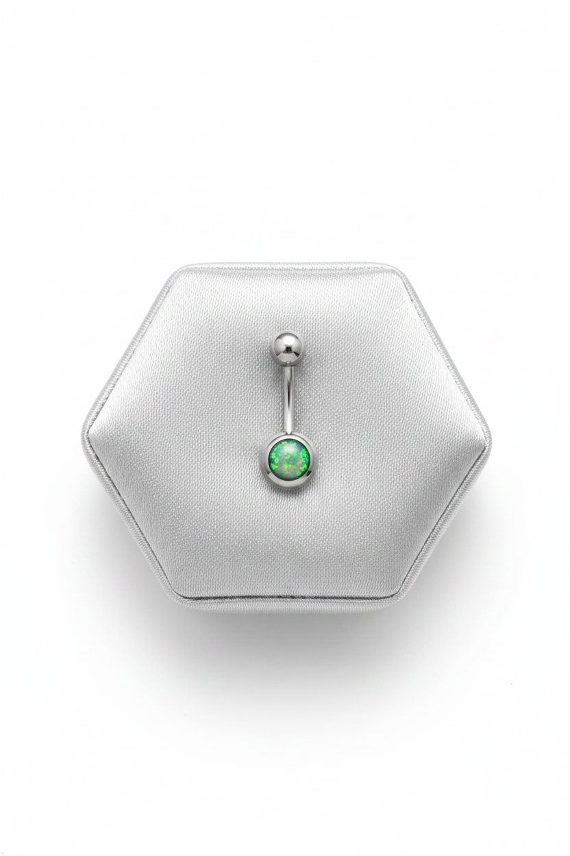 Green Opal Belly Button Ring in 316l stainless steel on a silver silk jewelry display.
