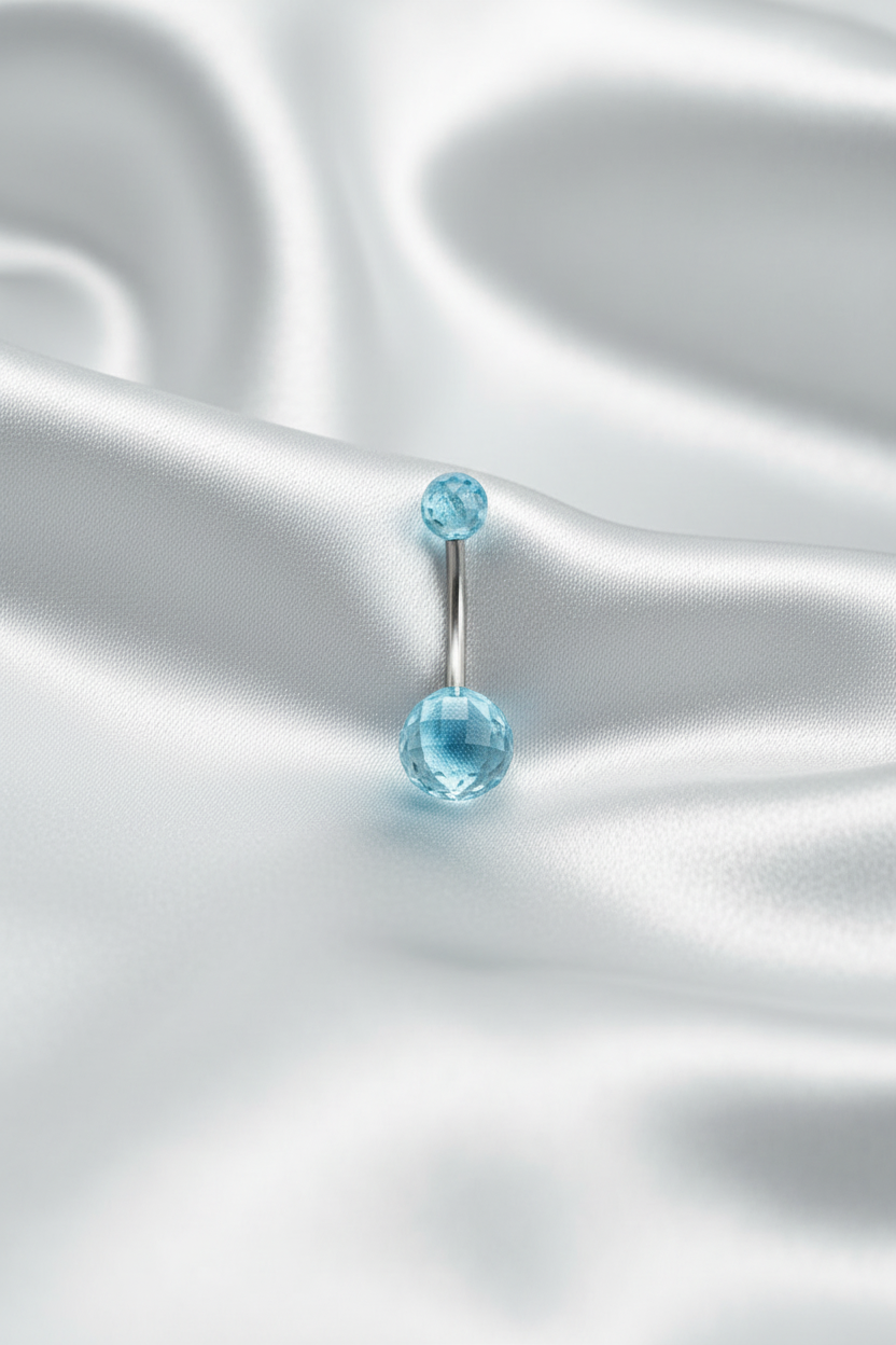 Blue Acrylic Disco Ball Belly Button Ring in 316l stainless steel on silver silk fabric.