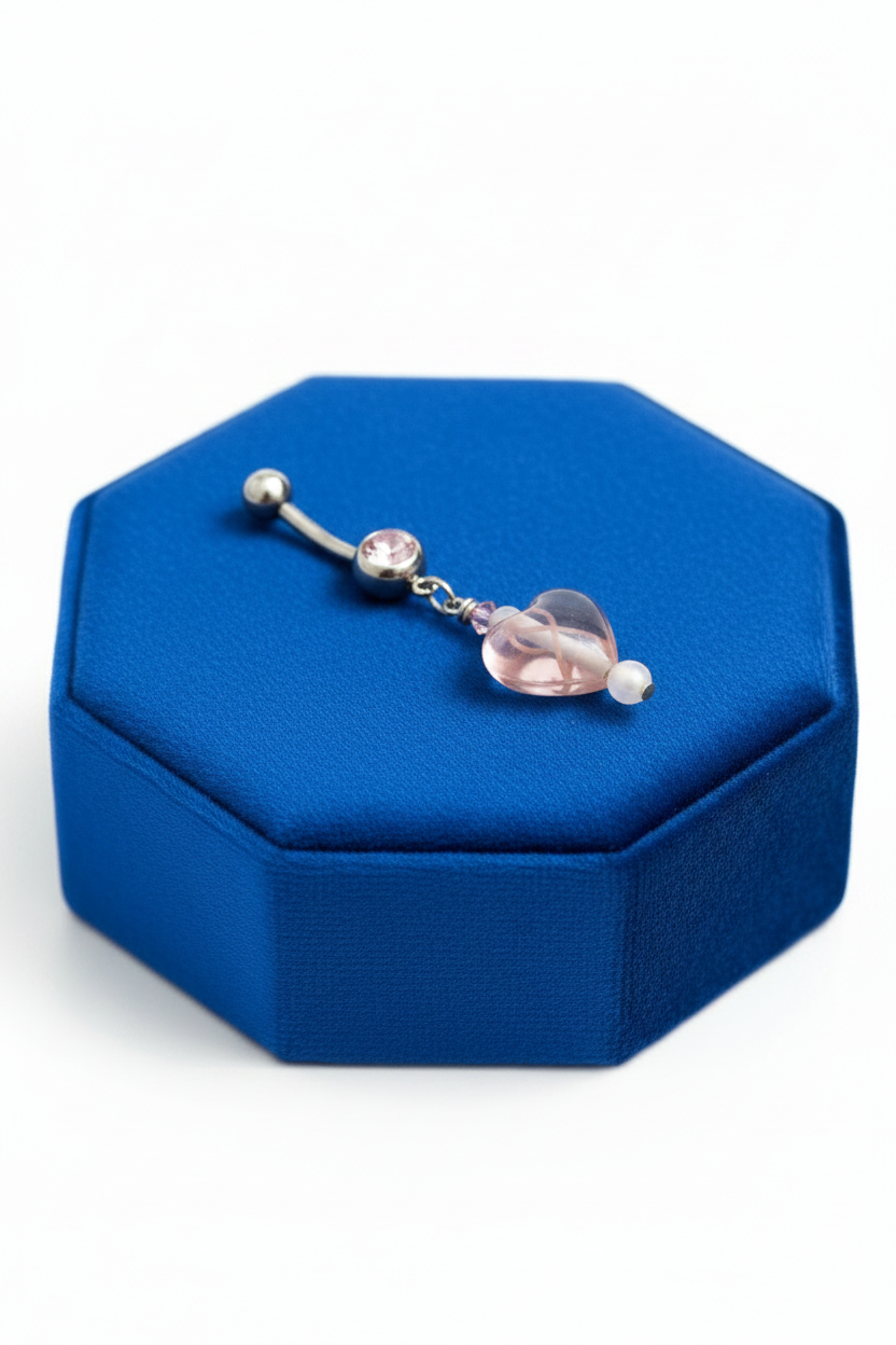 Pink Crystal Hope Ribbon Heart Belly Button Ring in 316l stainless steel on a blue velvet jewelry display.