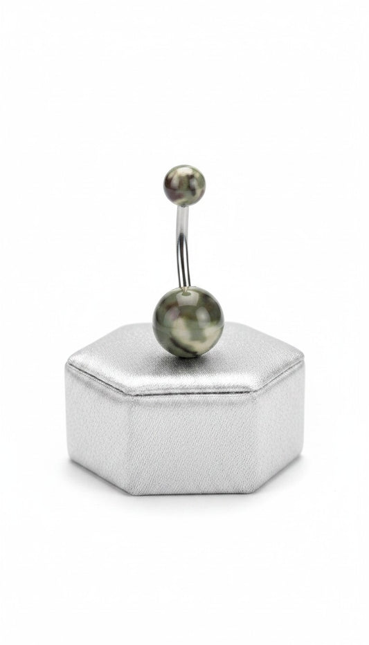 Green Camouflage Acrylic Belly Button Ring in 316l stainless steel on a silver jewelry display.