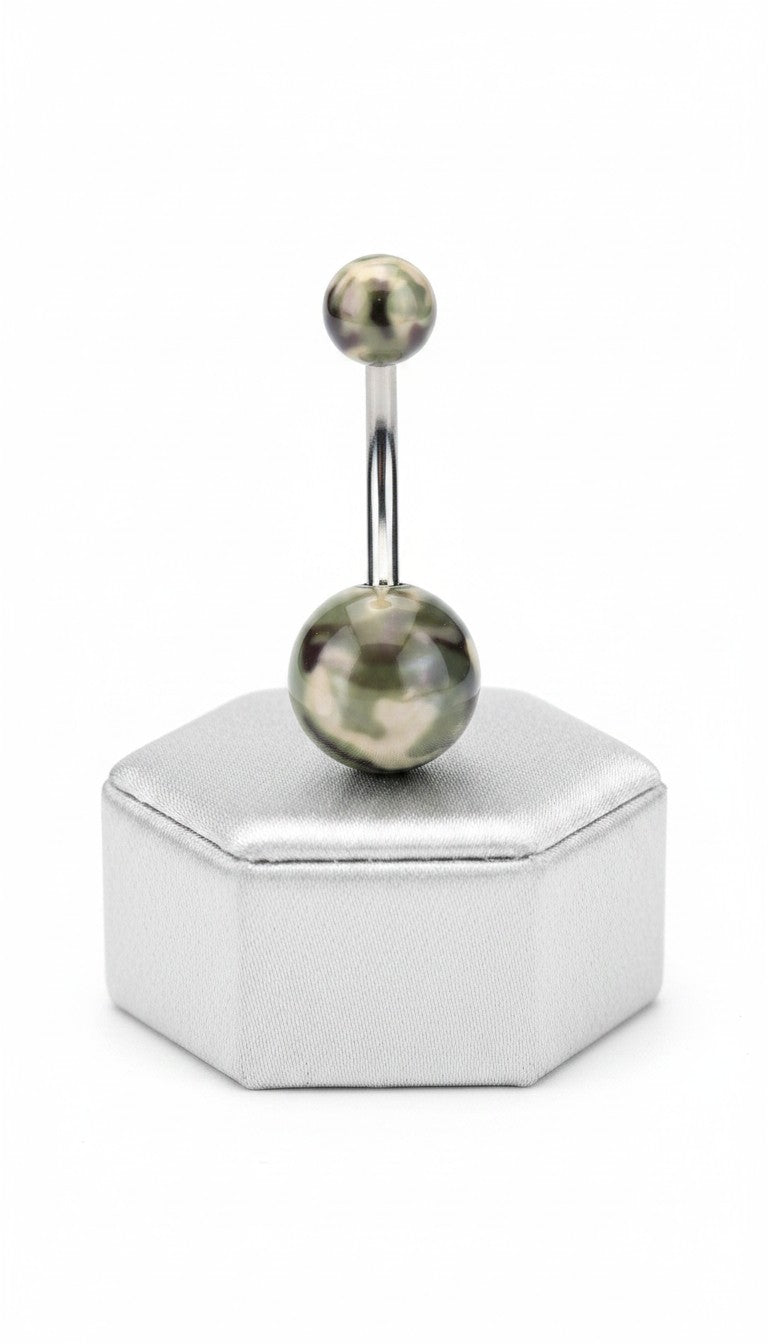 Green Camouflage Acrylic Belly Button Ring in 316l stainless steel on a silver jewelry display in close up detail.