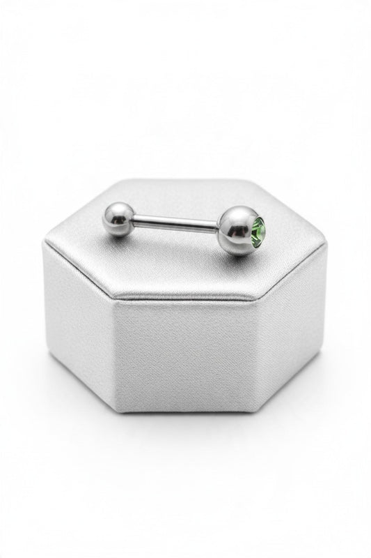 Green Crystal Tongue Barbell in 316l stainless steel on a silver silk jewelry display.