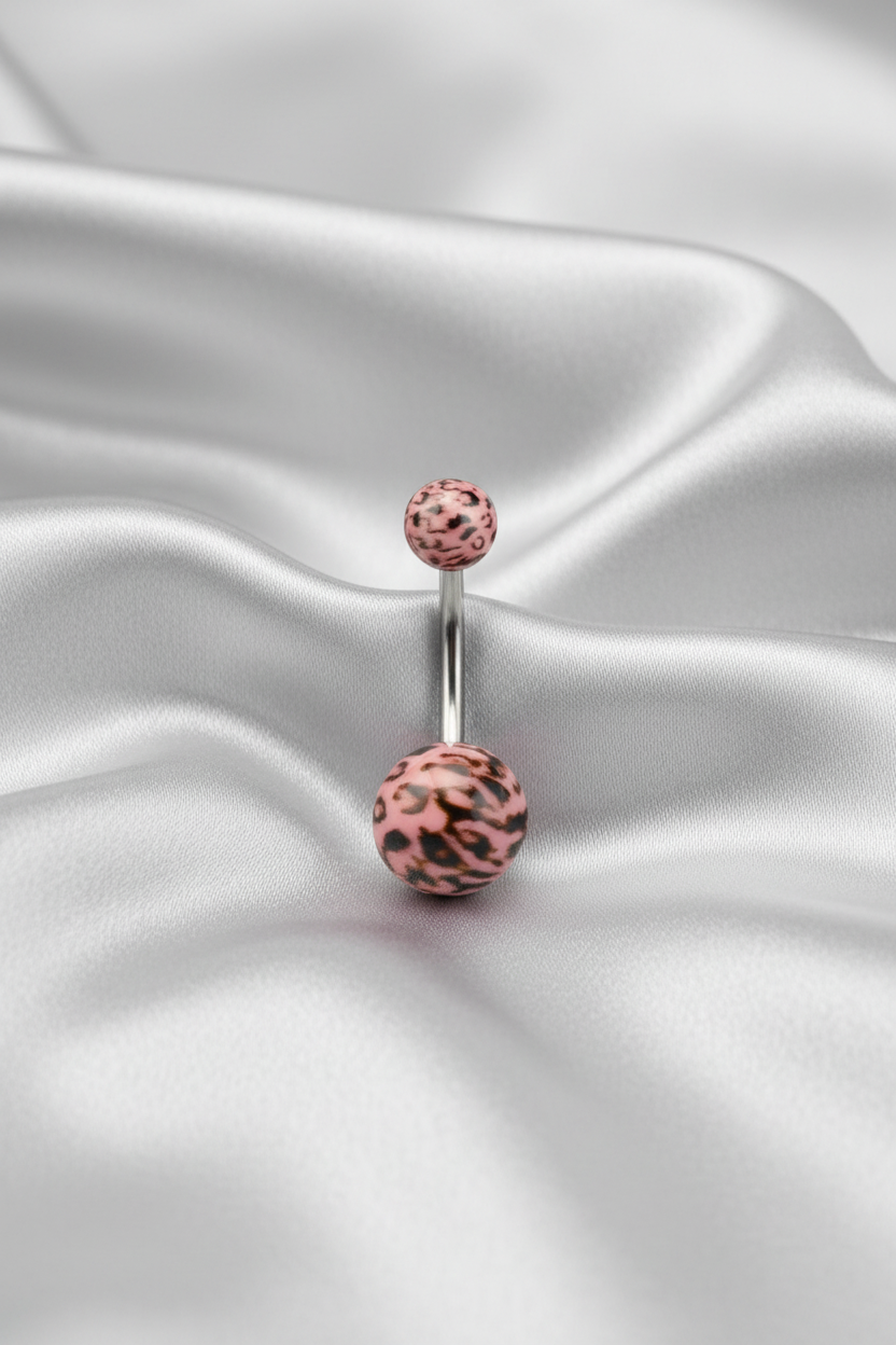 Pink Leopard Print Acrylic Belly Button Ring in 316l stainless steel on silver silk fabric.