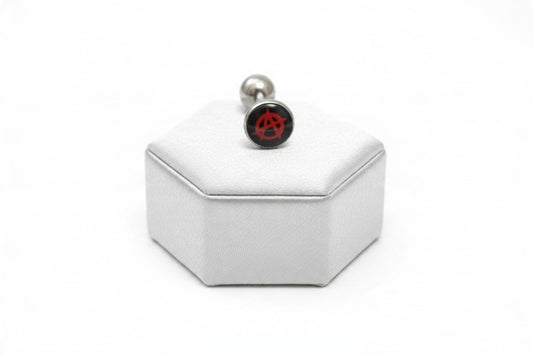 Red Anarchy Symbol Tongue Barbell in 316l stainless steel on a silver silk jewelry display.