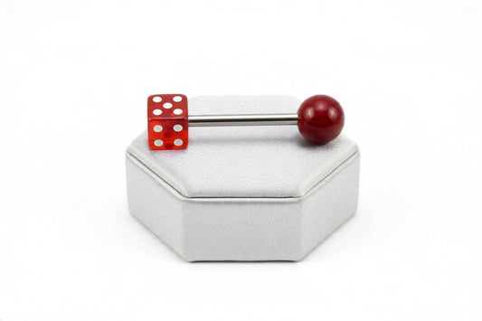 Red Dice Tongue Barbell in 316L stainless steel on a silver silk jewelry display.