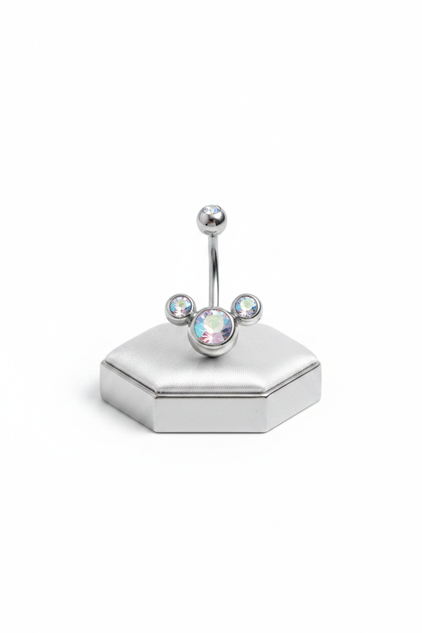 Clear Aurora Crystal Belly Button Ring in 316l stainless steel on a silver jewelry display upright position.