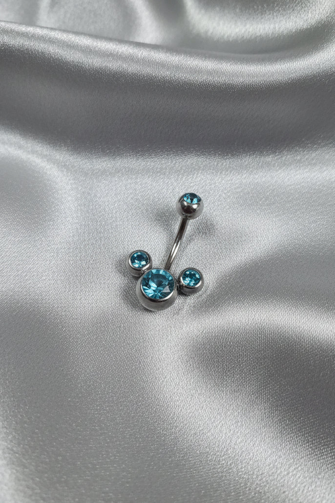 Aqua Crystal Belly Button Ring in 316l stainless steel on silver silk fabric.