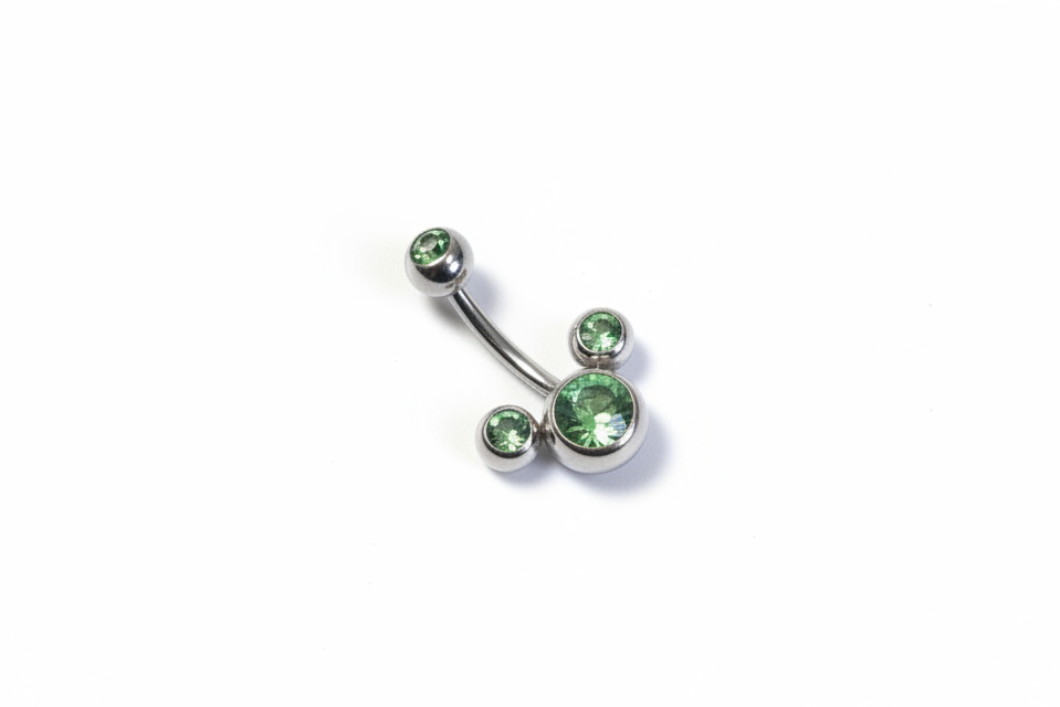 Green Crystal Belly Button Ring in 316l stainless steel on a white background.