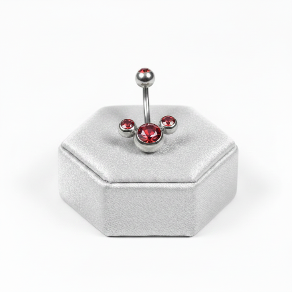Red Crystal Belly Button Ring in 316l stainless steel on a silver jewelry display upright angle.
