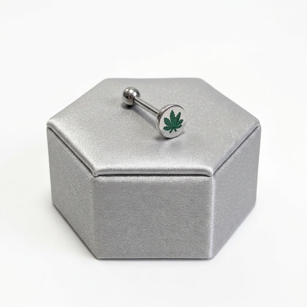 Steel Green Leaf Tongue Barbell in 316l stainless steel on a silver silk jewelry display.