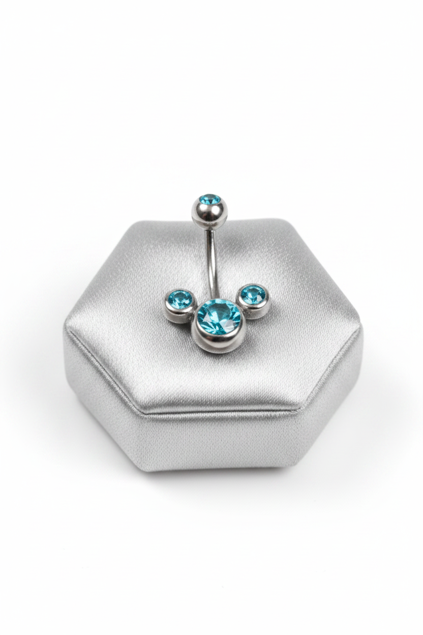 Aqua Crystal Belly Button Ring in 316l stainless steel on a silver jewelry display.