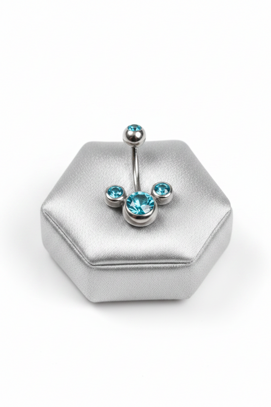 Aqua Crystal Belly Button Ring in 316l stainless steel on a silver jewelry display.