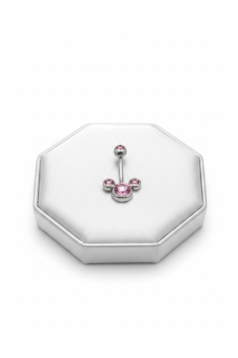 Pink Crystal Belly Button Ring in 316l stainless steel on a silver jewelry display.