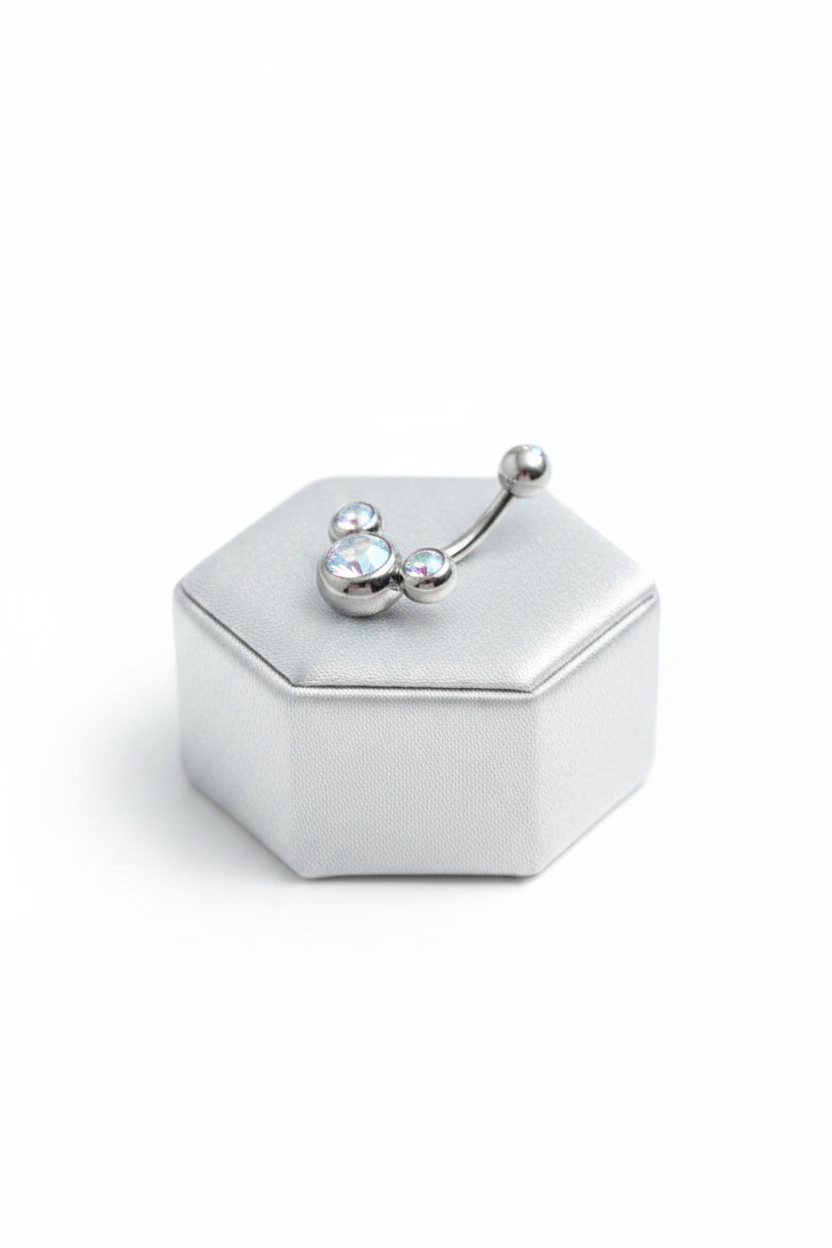 Clear Aurora Crystal Belly Button Ring in 316l stainless steel on a silver jewelry display.