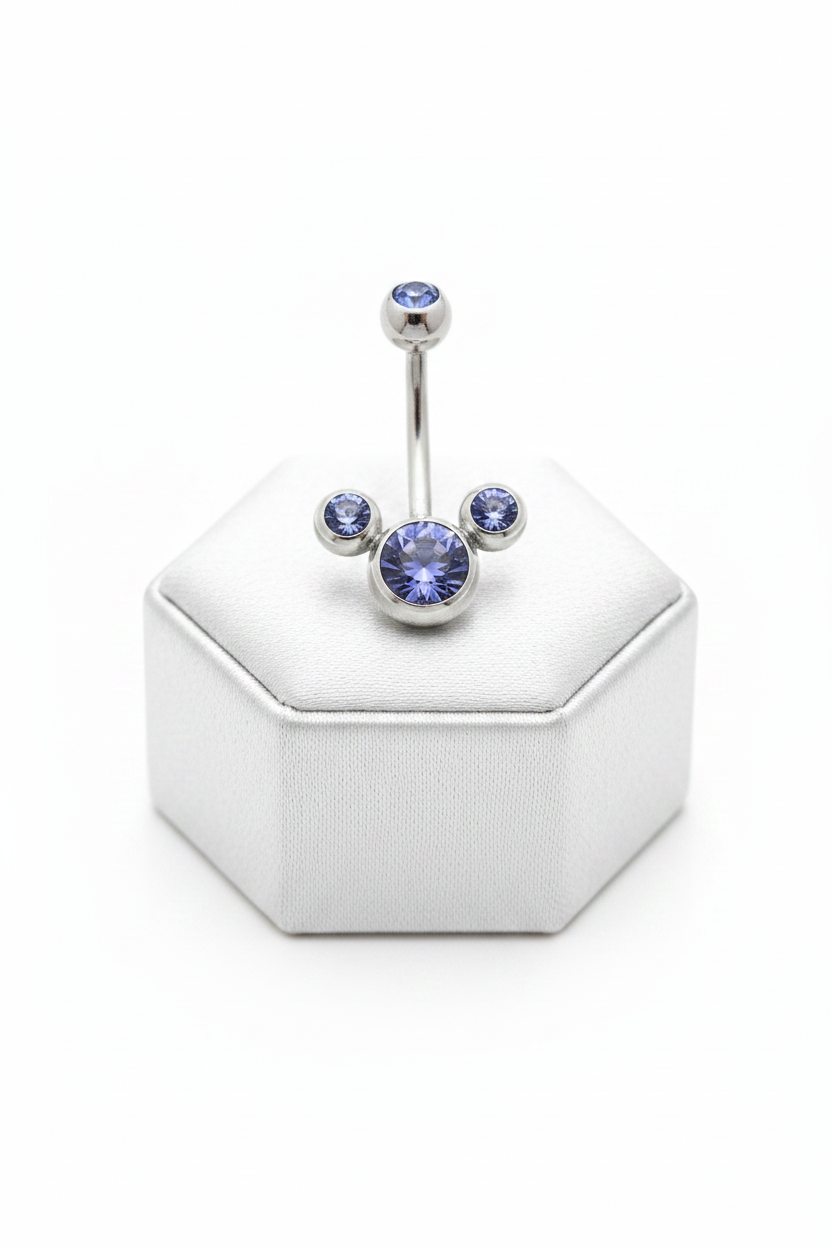 Purple Crystal Belly Button Ring in 316l stainless steel on a silver jewelry display upright position.