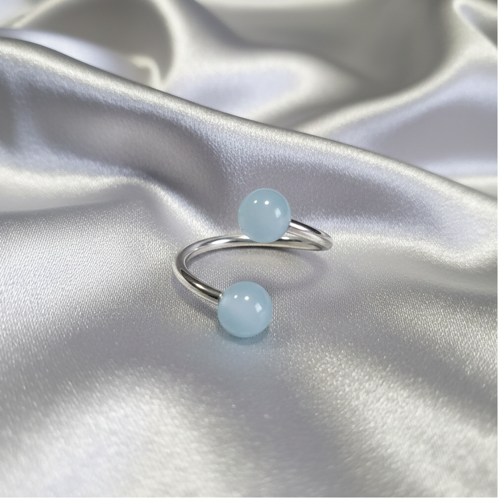 Baby Blue Acrylic Glow Curled Barbell in 316l stainless steel.
