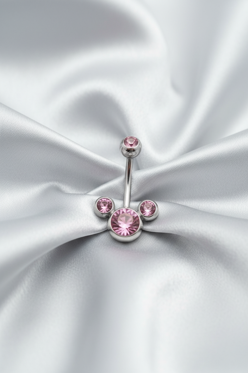 Pink Crystal Belly Button Ring in 316l stainless steel on silver silk fabric.