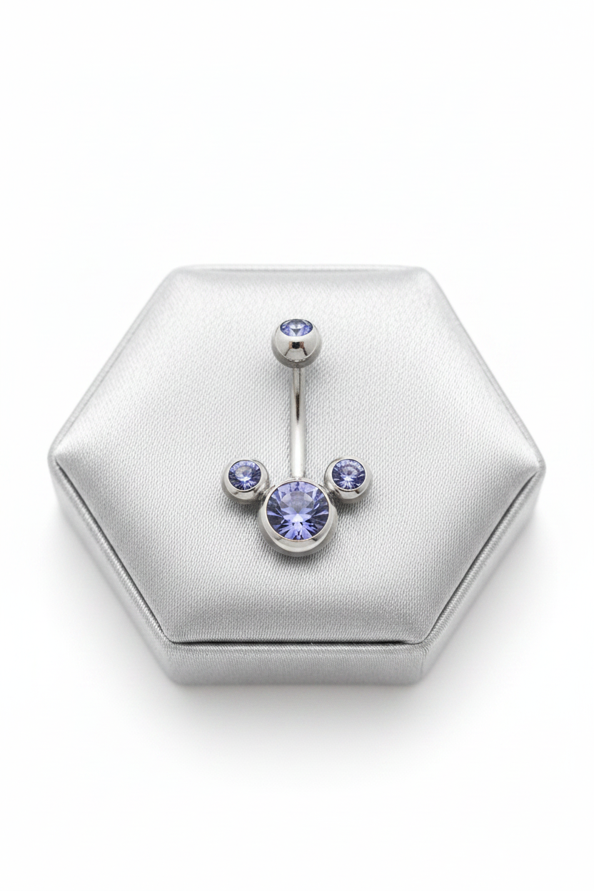 Purple Crystal Belly Button Ring in 316l stainless steel on a silver jewelry display.