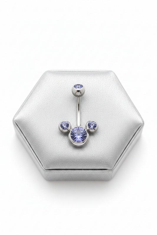 Purple Crystal Belly Button Ring in 316l stainless steel on a silver jewelry display.